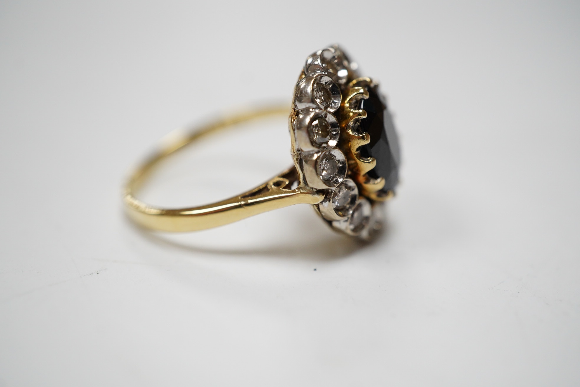 A modern 18ct gold, sapphire and diamond set oval cluster ring, size M, gross weight 5.3 grams. Condition - fair.